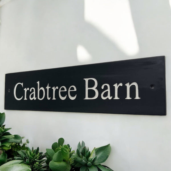 Introducing our stunning 40cm x 7.5cm Polished Natural Slate House Sign, designed to make a lasting impression! Crafted with durability in mind, it features beautifully carved lettering that enhances its elegance and visibility. Transform your home's entrance with this exquisite sign! www.HouseSign.co.uk