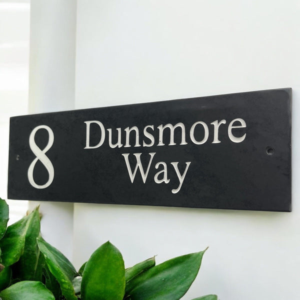 Introducing our stunning 40cm x 10cm Polished Natural Slate House Sign, designed to make a lasting impression! Crafted with durability in mind, it features beautifully carved lettering that enhances its elegance and visibility. Transform your home's entrance with this exquisite sign! www.HouseSign.co.uk