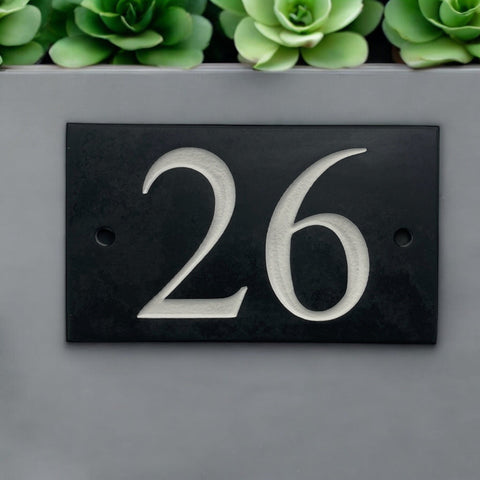 Introducing our stunning 12.5cm x 7.5cm Polished Natural Slate House Sign, designed to make a lasting impression! Crafted with durability in mind, it features beautifully carved lettering that enhances its elegance and visibility. Transform your home's entrance with this exquisite sign! www.HouseSign.co.uk