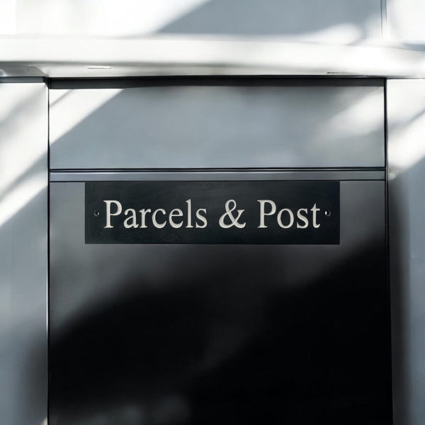 A natural slate carved sign saying Parcels & Post on a mailbox www.HouseSign.uk 