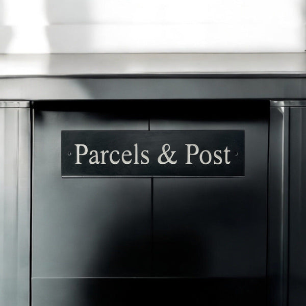 A natural slate carved sign saying Parcels & Post on a mailbox www.HouseSign.uk 